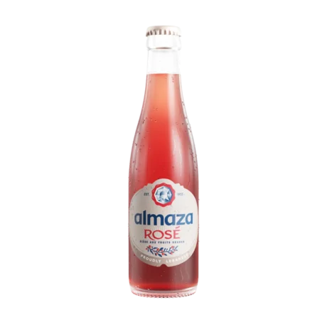 A chilled bottle of Almaza Rosé showing its vibrant pink color and fruit-themed label, a 2.7% ABV red fruit beer available for delivery in Amman, Jordan.