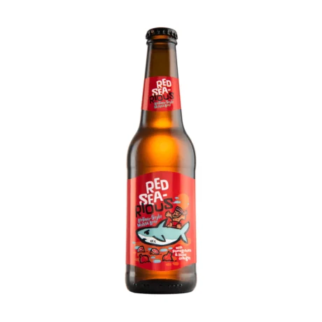A bottle of Carakale Red Sea-rious showing its golden color and the iconic label inspired by the Red Sea, a premium 5% ABV fruited sour wheat beer available in Amman.